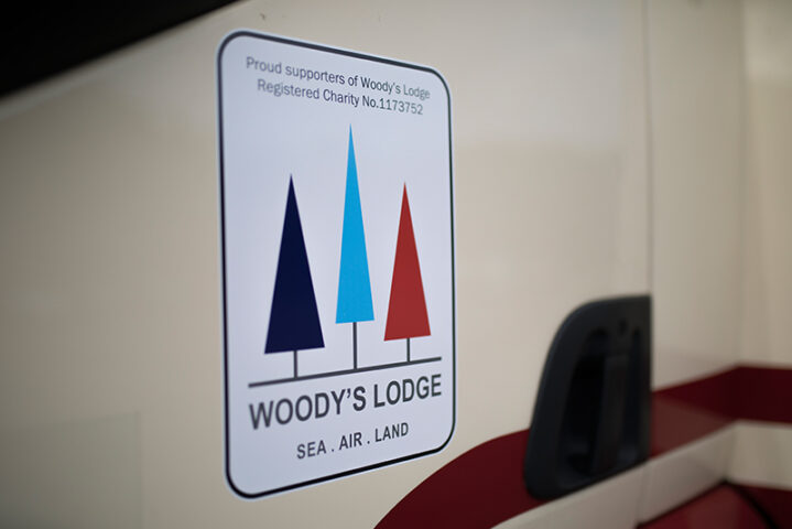 Woody's Lodge logo on Masons Removals Cardiff van