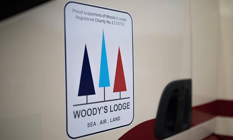 Woody's Lodge logo on Masons Removals Cardiff van